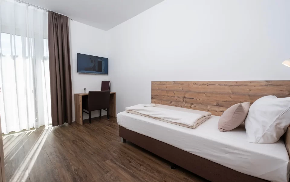 Single bed with a wooden headboard