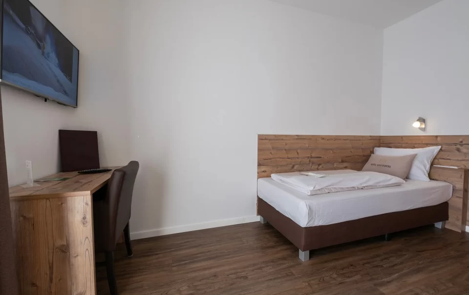 Single bed with a wooden headboard