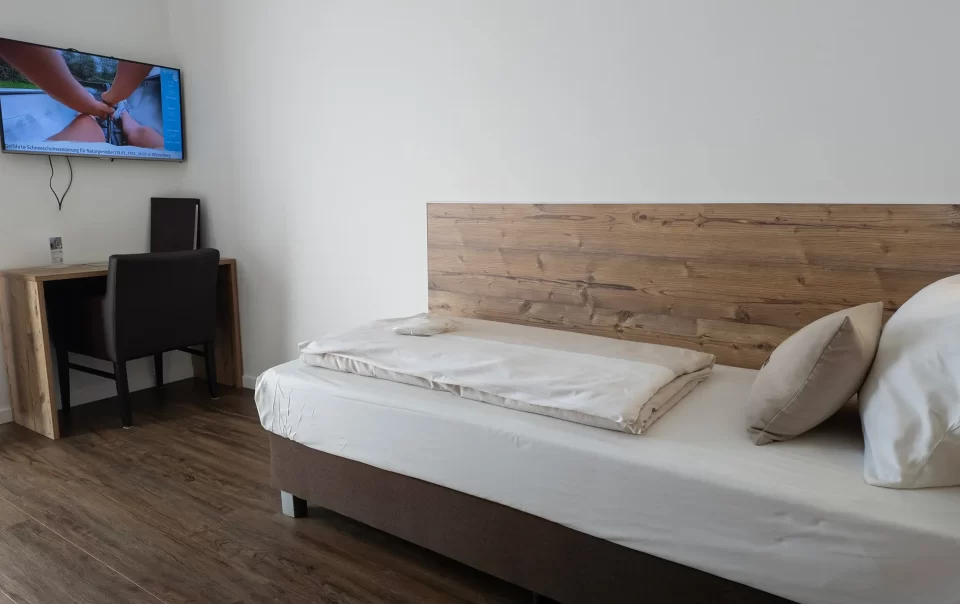 Single bed with a wooden headboard