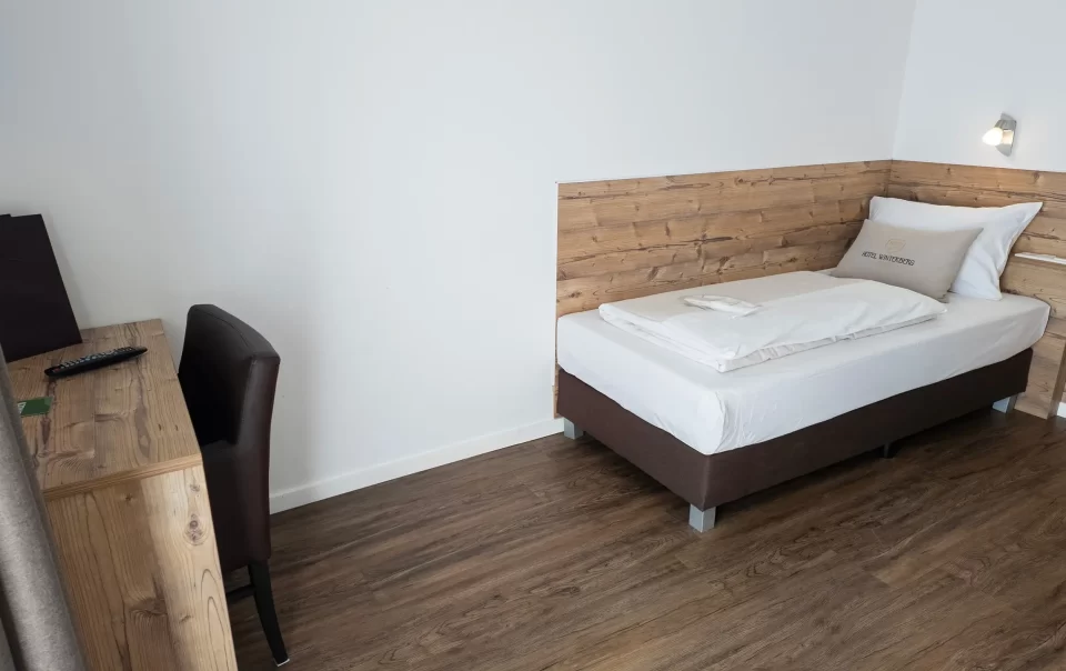 Single bed with a wooden headboard