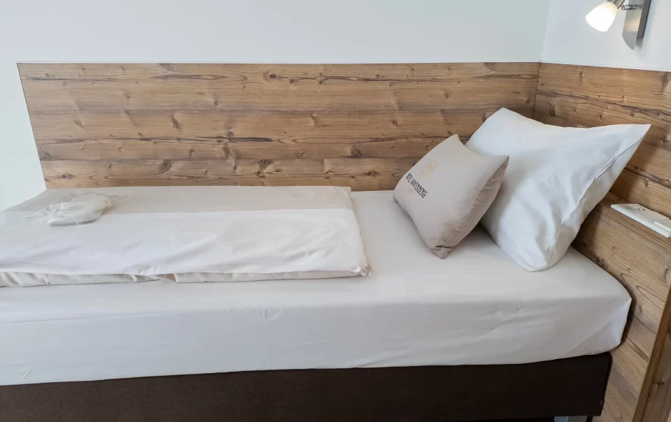 Single bed with a wooden headboard