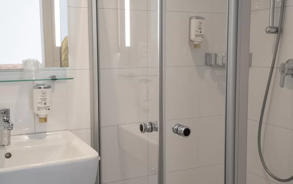 Washbasin and glass shower in the bathroom