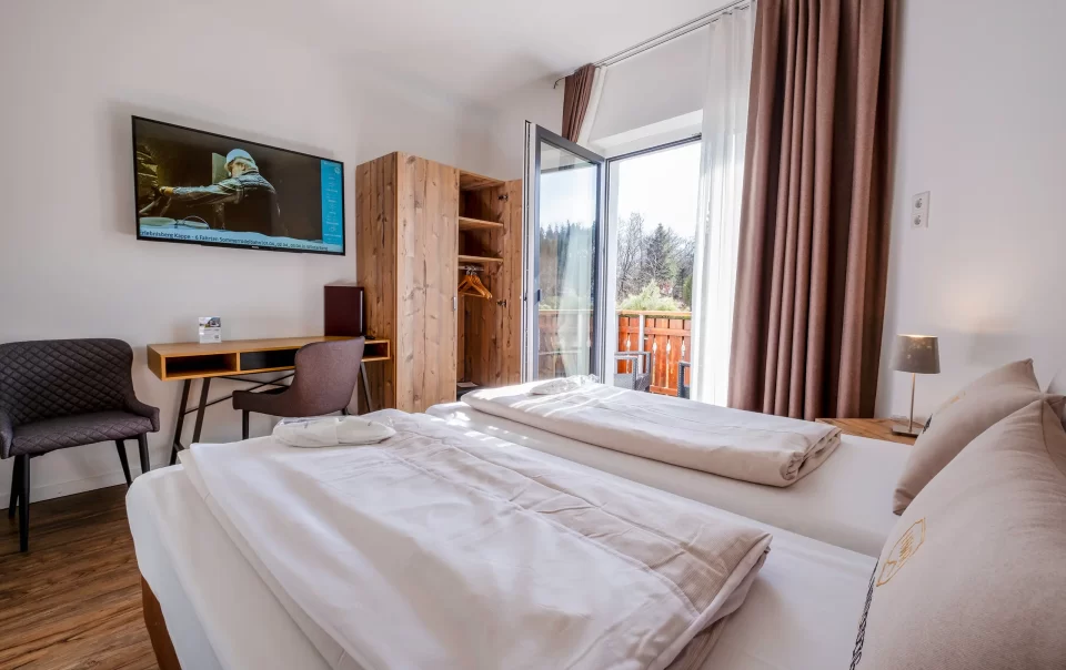 Double bed beside an open balcony doorway