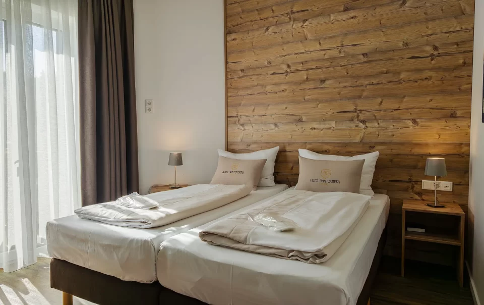 Double bed against a wooden feature wall