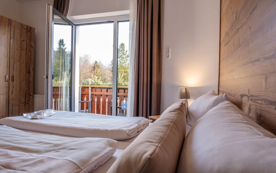 Double bed beside an open balcony doorway