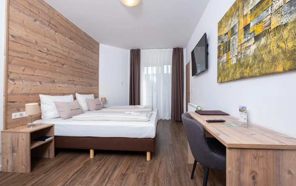 Double bed against a wooden feature wall