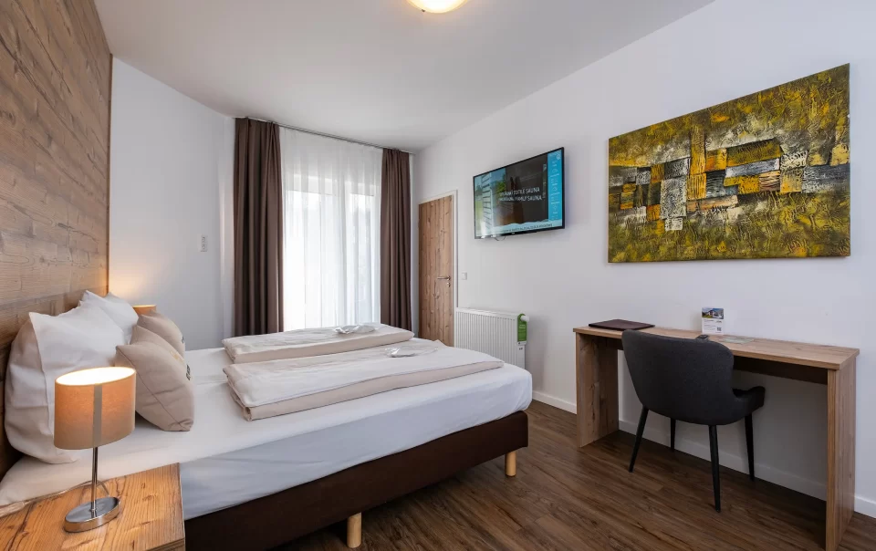 Double bed against a wooden feature wall
