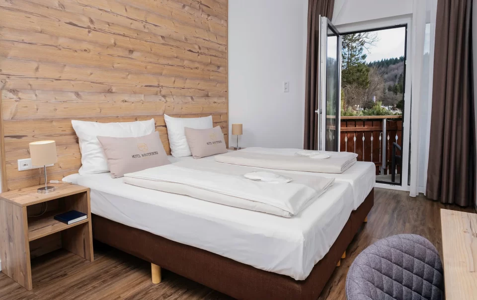 Double bed beside an open balcony doorway