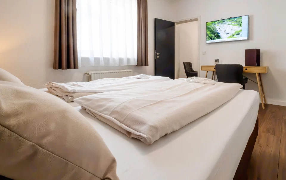 Beds beside a television and seating area