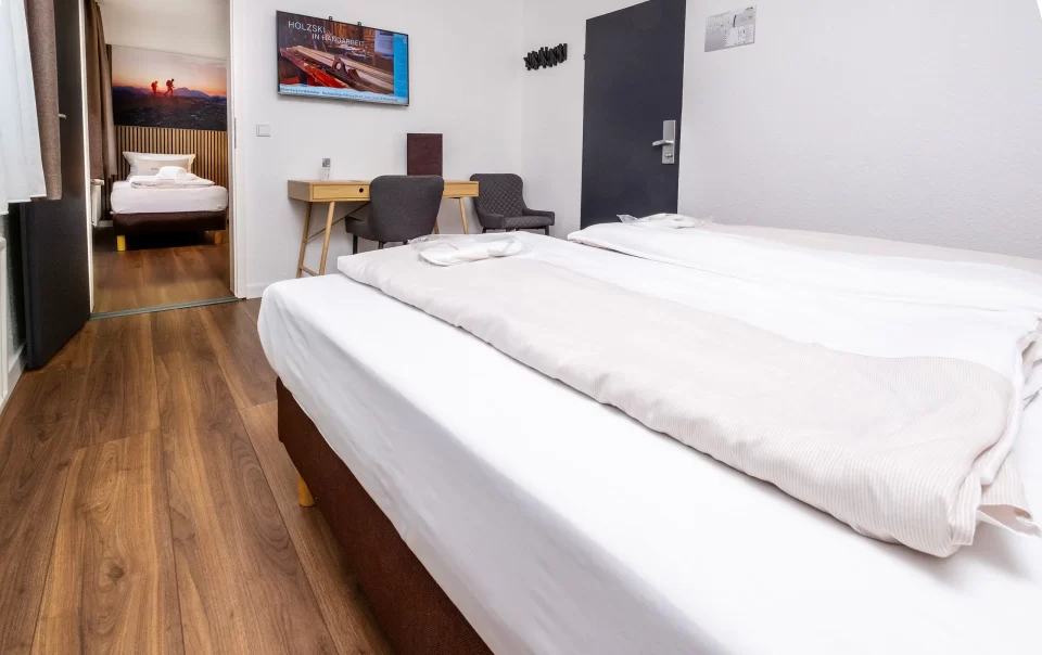 Beds beside a television and seating area
