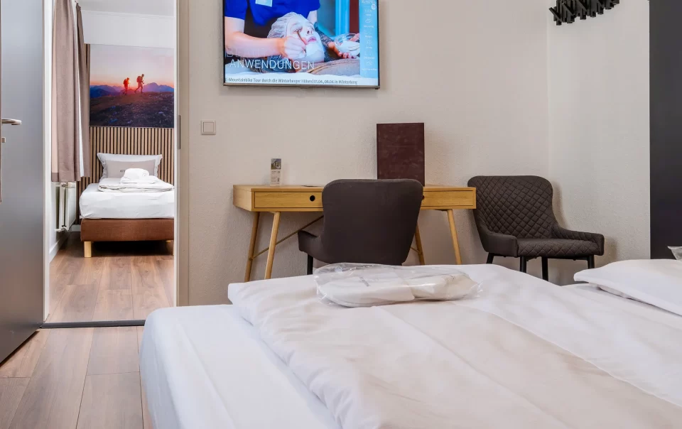 Beds beside a television and seating area
