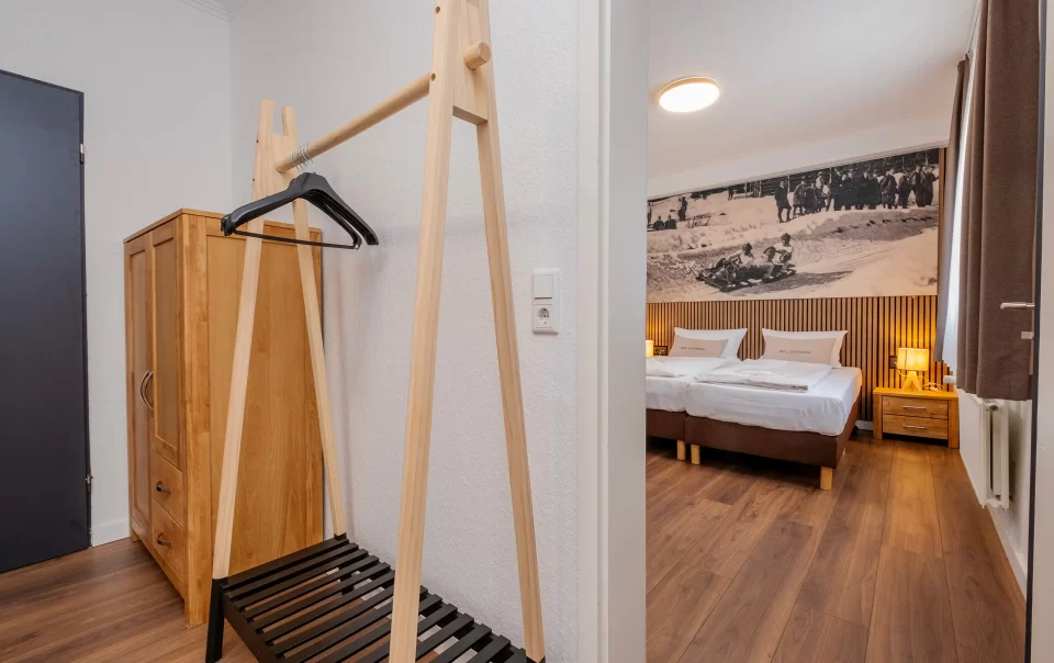 Wooden clothes rail beside the bedroom entrance
