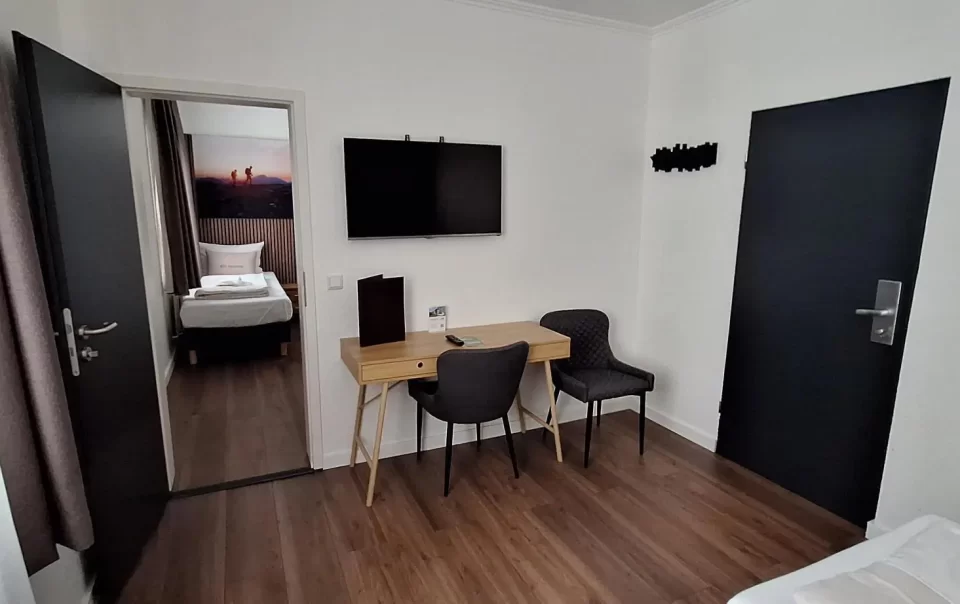 Wall-mounted television above bedroom chairs