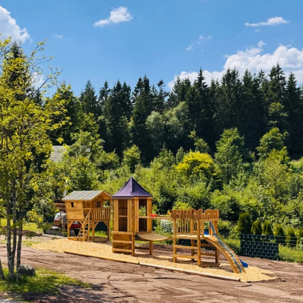 Outdoor playground with a wooden playhouse