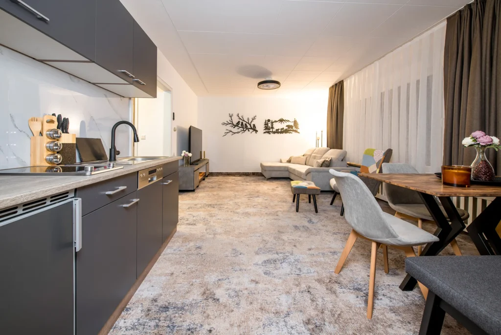 Living area with sofa, armchairs and dining table