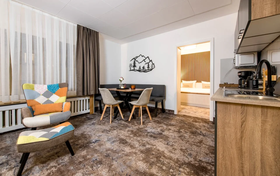 Living area with sofa, armchairs and dining table