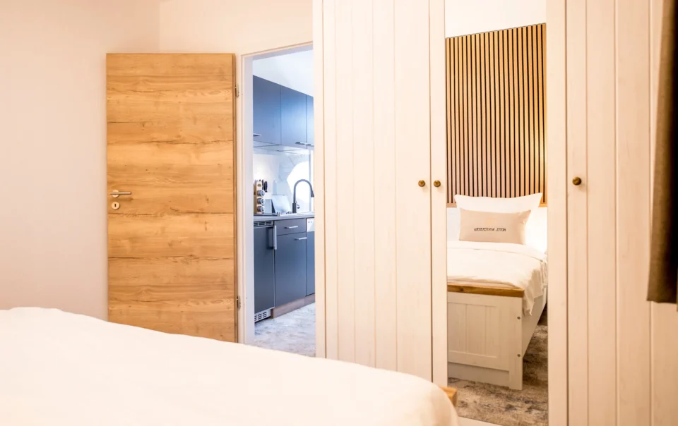 Double bed against a wood-panelled wall