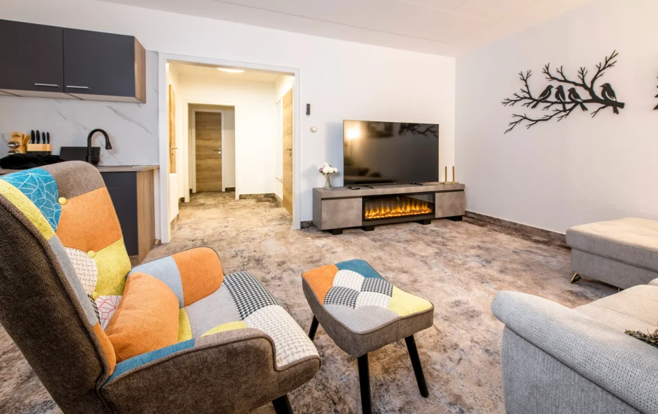 Living area with sofa, armchairs and dining table