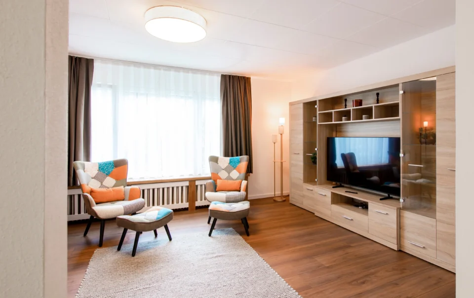 Living area with sofas, armchairs and a large television