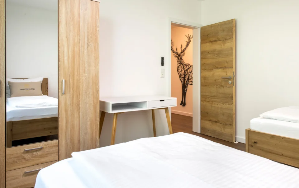 Writing desk beside a wooden bedroom door