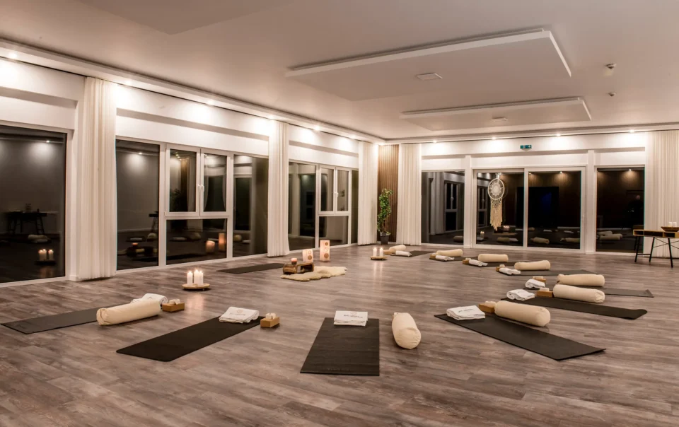 Yoga room prepared with mats, cushions and candles