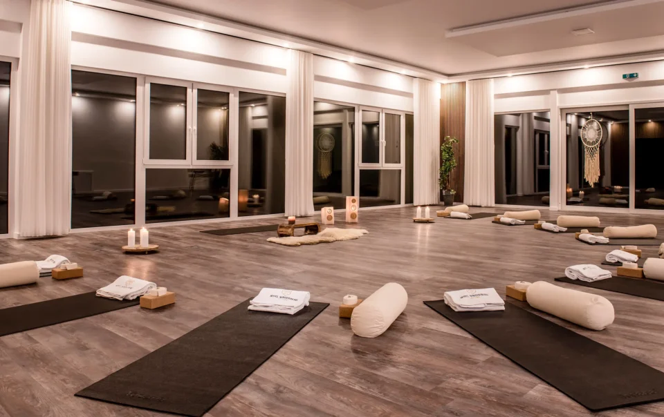 Yoga room prepared with mats, cushions and candles