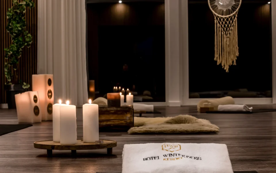 Yoga room prepared with mats, cushions and candles
