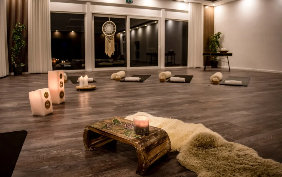 Yoga room prepared with mats, cushions and candles