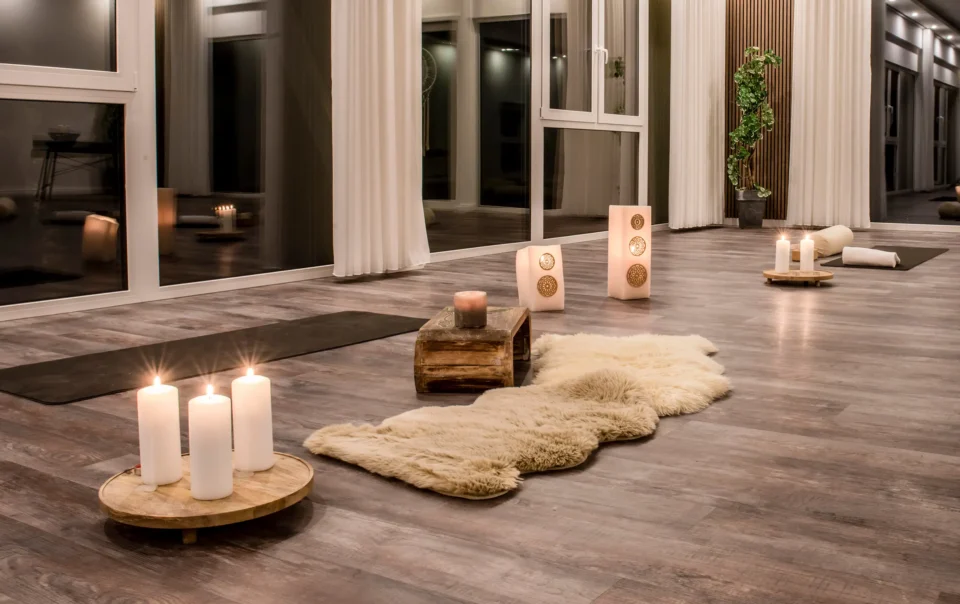 Yoga room prepared with mats, cushions and candles