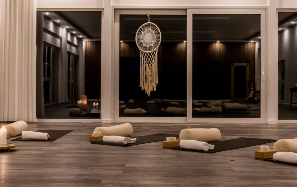 Yoga room prepared with mats, cushions and candles