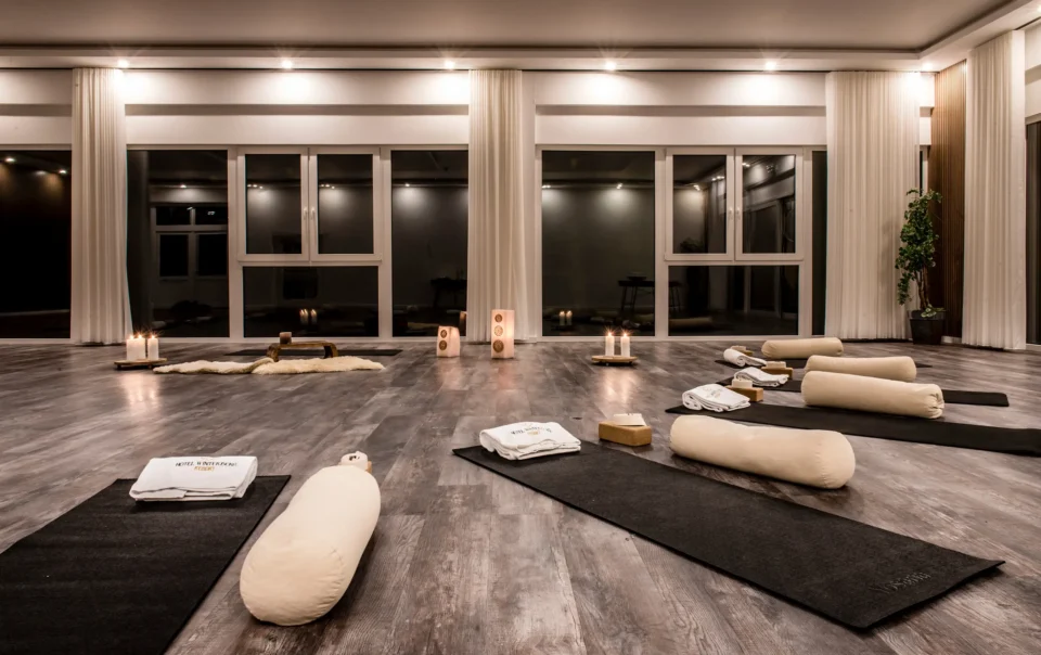 Yoga room prepared with mats, cushions and candles