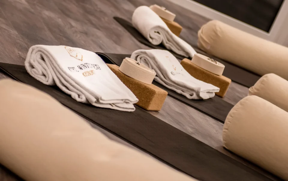 Yoga mats with blocks, bolsters and folded towels