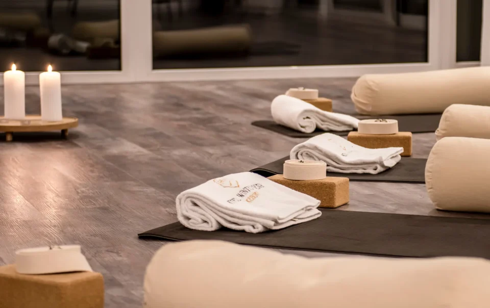 Yoga mats with blocks, bolsters and folded towels