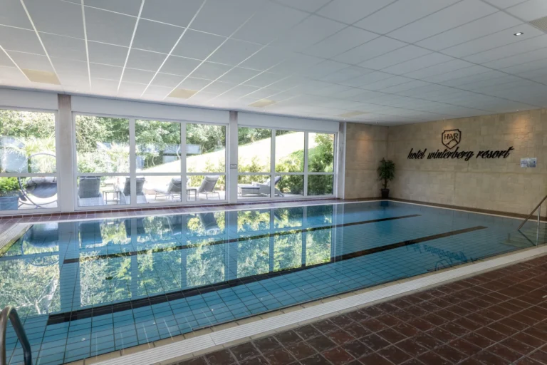 Indoor swimming pool overlooking the garden at Hotel Winterberg Resort
