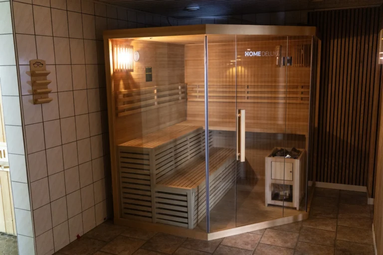 Glass-fronted wooden sauna at Hotel Winterberg Resort