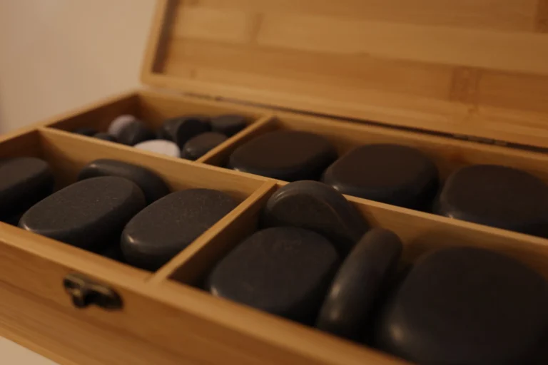 Massage stones arranged in a wooden box at Hotel Winterberg Resort