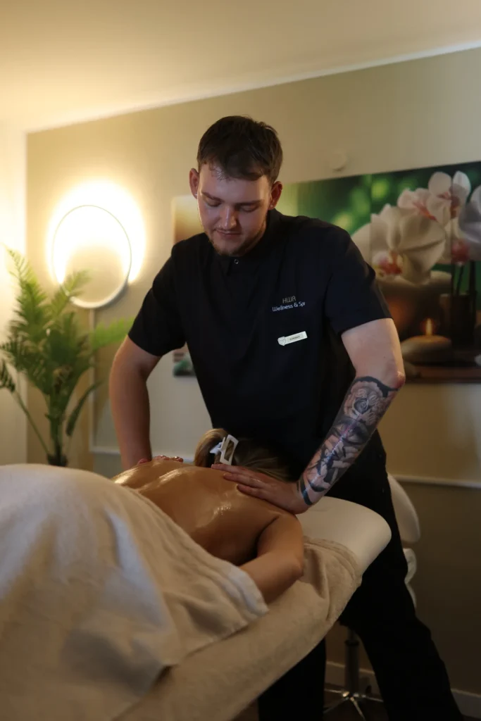 Therapist giving a back massage in the spa at Hotel Winterberg Resort